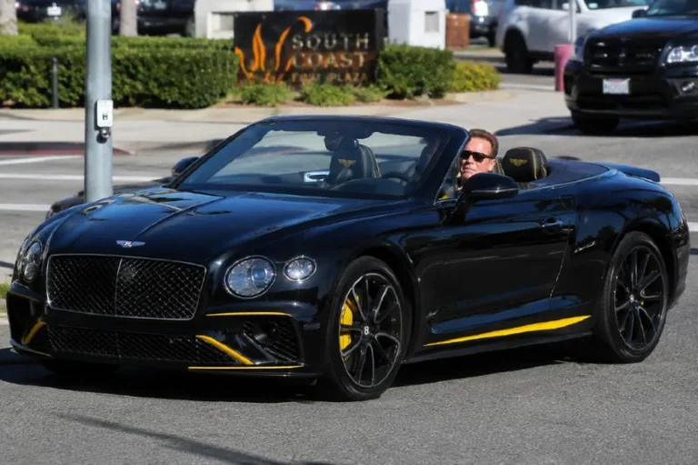 Arnold Schwarzenegger driving or standing beside his Bentley Continental GT Speed Convertible featuring all black exterior and interior with striking yellow accents representing one of three Bentleys in his collection alongside the Continental GT Supersports Convertible valued at over 320000 dollars and the Bentley Arnage with BMW sourced V8 engine and Cosworth twin turbo setup with the GT Speed producing 616 horsepower from its 6.0 liter twin turbocharged W12 engine and a top speed of 200 mph