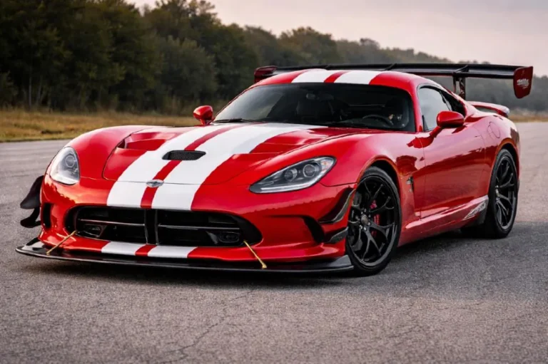 Fifth generation Dodge Viper ACR in Viper Red with white stripes showing the Extreme Aero Package including massive carbon fiber rear wing front splitter and dive planes that generate 1700 pounds of downforce and set the 2017 Nurburgring production car lap record of 7 minutes 01 seconds