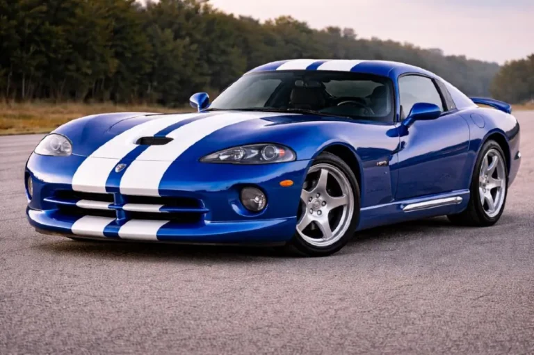 Dodge Viper GTS coupe in classic GTS Blue Metallic with white racing stripes showing the iconic double bubble roofline designed to accommodate helmets for track use alongside the wide muscular rear haunches that made the 1996 to 2002 GTS the most visually iconic American sports car of its era