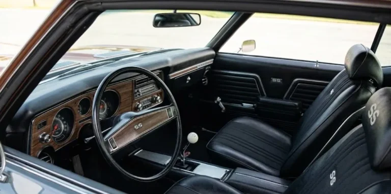 1969 Chevrolet Chevelle SS interior showing the optional bucket seats with SS embroidered headrests the floor mounted four speed Muncie shifter sport steering wheel and gauge cluster of the muscle car cockpit that balanced functional performance orientation with genuine comfort showing the circular HVAC vents and center console that distinguished the SS configuration from the standard Malibu interior