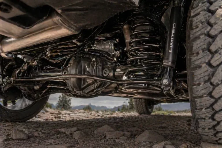 Ram 1500 rear coil spring suspension system showing the coil spring rear suspension architecture that makes the Ram 1500 the most comfortable riding full size pickup truck according to Consumer Reports for multiple consecutive years replacing the leaf spring rear suspension used by every other full size pickup manufacturer including Ford F-150 and Chevrolet Silverado with a setup that absorbs road irregularities more completely and transmits less noise vibration and harshness to the passenger compartment