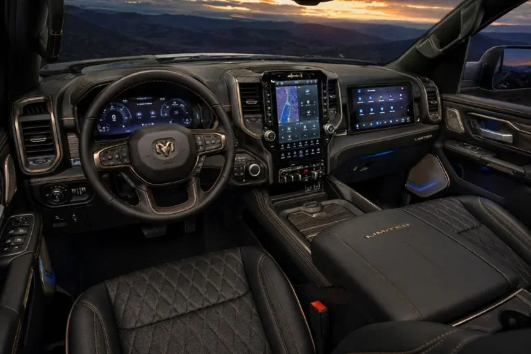 2026 Ram 1500 Limited interior showing the primary 12 inch Uconnect 5 touchscreen and passenger side infotainment touchscreen the premium quilted black leather upholstered front seats with heating ventilation and massaging functions genuine wood interior trim appliqués ambient lighting illuminating the cabin architecture and the overall luxury environment that makes the Limited the most refined standard production Ram 1500 available below the Tungsten