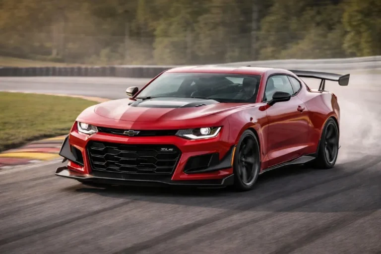 Chevrolet Camaro ZL1 1LE in track action showing the front splitter side strakes and rear wing aerodynamic package alongside the Multimatic DSSV spool valve dampers that replaced Magnetic Ride Control and produced a Nürburgring Nordschleife lap time of 7 minutes 16.04 seconds placing the front engine American muscle car among the fastest production cars ever to lap the circuit regardless of price