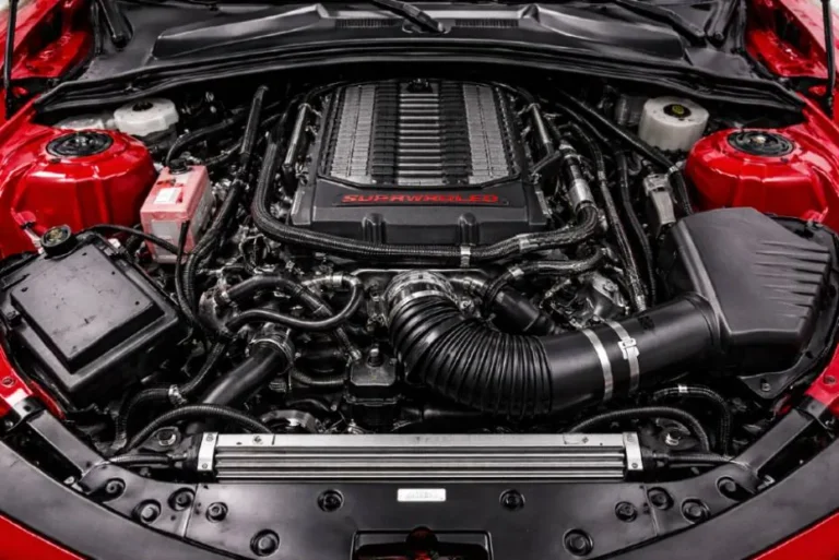 The LT4 6.2 liter supercharged V8 engine with Eaton TVS R1740 roots type supercharger in the Camaro ZL1 producing 650 horsepower and 650 lb-ft of torque using direct injection and liquid to air charge cooling in the front engine rear wheel drive layout that defines the traditional American muscle car architecture and delivers the characteristic deep exhaust note and broad torque band that supercharged cross plane V8s have always produced