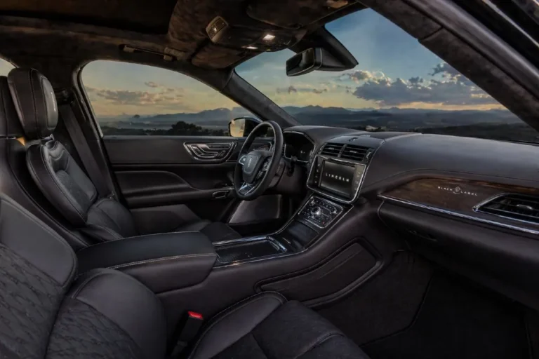 2019 Lincoln Continental Black Label interior showing the Thoroughbred or Chalet interior theme with Alcantara headliner Venetian leather specialty seats Chilean Maple or Silverwood appliqués and the complete luxury environment that distinguishes the Black Label from lower Continental trims including the 30 way adjustable massaging front seats the ambient lighting system and the standard all wheel drive and Revel Ultima audio system