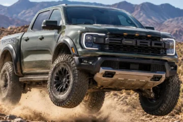 2026 Ford Ranger Raptor SuperCrew 4x4 showing the widened fenders aggressive stance bold FORD grille lettering and 33-inch BFGoodrich KO3 all-terrain tires on 17-inch beadlock-capable wheels in an off-road action setting powered by the 3.0-liter twin-turbocharged V6 EcoBoost producing 405 horsepower and 430 lb-ft of torque with FOX 2.5-inch Live Valve shocks Watts-link rear suspension 11.7 inches of ground clearance and seven selectable drive modes including Baja starting at 56070 dollars