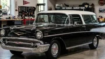 1957 Chevrolet Nomad showing the updated front fascia with larger tailfins and rounded chrome grille that distinguished it from the 1955 and 1956 models the rarest of the three Tri-Five Nomad production years with only 6103 units built available with the revolutionary fuel injected 283 cubic inch V8 that achieved one horsepower per cubic inch making it the first American production car to reach that milestone and the most sought after and most valuable configuration in the current Nomad collector market