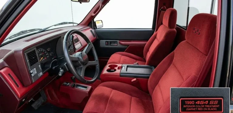 The Garnet Red cloth bucket seat interior with center console of the 1990 Chevrolet 454 SS truck showing the specific red on black color combination exclusive to the 1990 model year before additional interior colors were offered in 1992 the Silverado grade appointments and the center console configuration that along with the bucket seats is standard on all genuine 454 SS trucks distinguishing them from bench seat standard C1500 conversions