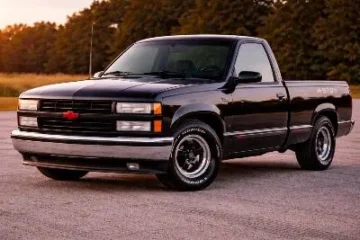 1990 Chevrolet C1500 454 SS truck in Onyx Black the only available first year color showing the blacked out egg crate grille chrome sport wheels with 275/60R15 tires 454 SS bedside decals and lowered stance of the original American muscle truck that produced 230 horsepower and 385 lb-ft of torque from its L19 7.4 liter big block V8 with only approximately 13748 units built in the first year of production