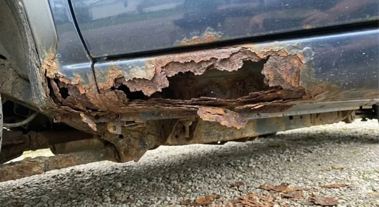 Significant structural rust on a vehicle's rocker panel or floor pan showing rust penetration that compromises structural integrity distinguishing it from surface oxidation on brake rotors or suspension components that is cosmetic and manageable representing the most serious structural concern on any used American sports car purchase under 10000 dollars particularly on northern-market examples exposed to road salt requiring inspection with a flashlight and probe tool before any purchase decision