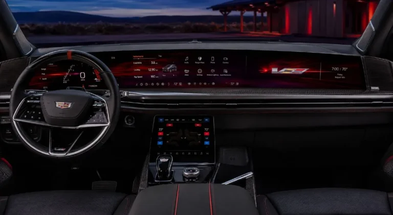 Cadillac Escalade-V interior showing the full 55-inch curved pillar-to-pillar Horizon Display with carbon fiber surrounds and red digital accents exclusive to the V-Series trim divided into a 35-inch driver and center infotainment zone and a separate 20-inch passenger entertainment zone running Google Built-in with wireless Apple CarPlay and Android Auto alongside the semi-aniline leather seating and V-Series exclusive interior appointments