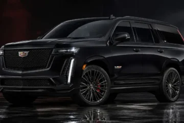 Cadillac Escalade-V in black exterior showing the 24-inch wheels redesigned vertical headlight signature redesigned grille with mail slot cooling opening below and V-Series badging of the 682 horsepower supercharged 6.2 liter V8 hand-built luxury SUV starting at 170595 dollars reaching 0-60 mph in 4.4 seconds with standard AWD Magnetic Ride Control 4.0 Brembo front performance brakes V-Mode with launch control and a 55-inch curved pillar-to-pillar Horizon Display
