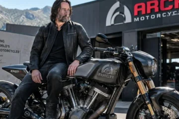 Keanu Reeves at ARCH Motorcycle facility or riding one of his motorcycles representing his co-founded motorcycle company ARCH Motorcycle established in 2011 with Gard Hollinger producing the KRGT-1 at approximately 85000 dollars with over 200 handmade parts and Öhlins suspension alongside his documented car collection valued at over 3.8 million dollars including a 1964 Volvo 122 nicknamed Dumpy a Porsche 911 Carrera 4S nicknamed The Sled and a Ferrari LaFerrari valued at approximately 3.5 million dollars